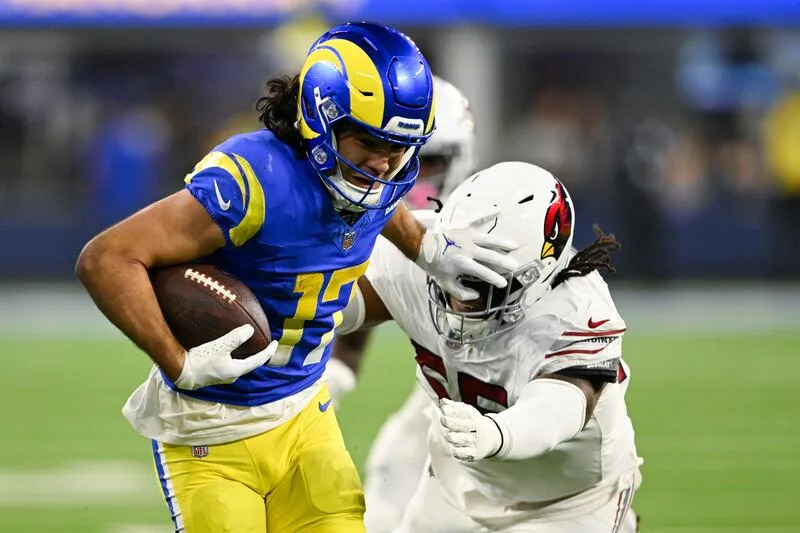 Los Angeles Rams wide receiver Puka Nacua (17) stiff-arms Arizona Cardinals defensive tackle Dante Stills (55) after a reception during the second half of an NFL football game Saturday, Dec. 28, 2024, in Inglewood, Calif. | Alex Gallardo