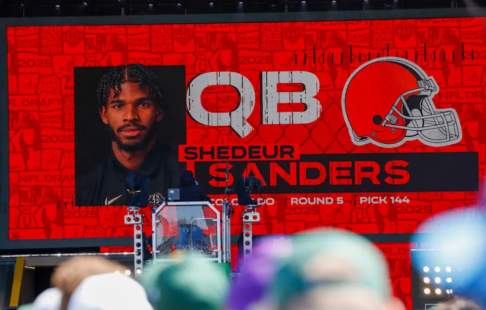 A graphic announcing Colorado quarterback Shedeur Sanders’ selection by the Cleveland Browns with the 144th overall pick is seen in the Draft Theater during the third day of the 2025 NFL draft.Tork Mason/USA Today Network via Imagn Images