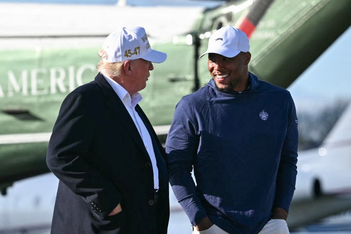 President Donald Trump walks with Philadelphia Eagles running back Saquon Barkley before boarding Air Force One Morristown Municipal Airport in Morristown, New Jersey, on Sunday.
