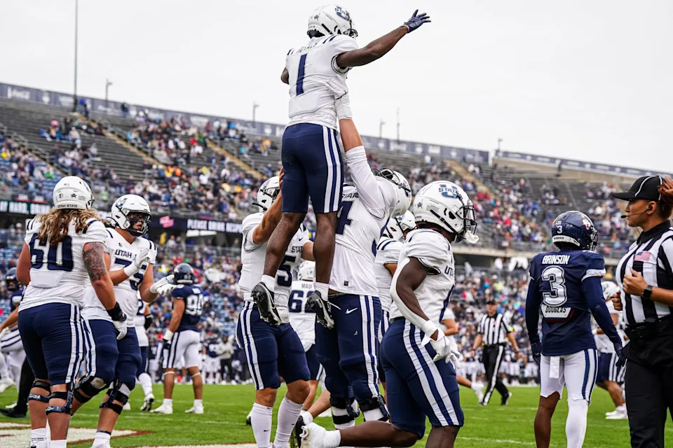 Sep 30, 2023; East Hartford, Connecticut, USA; Utah State Aggies wide receiver Jalen Royals (1) is congratulated after his touchdown catch against the UConn Huskies in the second half at Rentschler Field at Pratt & Whitney Stadium. Mandatory Credit: David Butler II-USA TODAY Sports