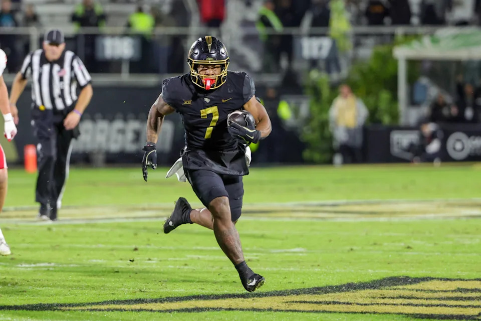 UCF Knights running back RJ Harvey (7) runs the ball during the second quarter against the Utah Utes at FBC Mortgage Stadium.Mike Watters-Imagn Images