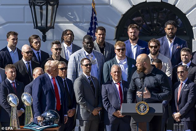 Ricks (back row, third from left) is seen among Eagles players and coaches on Monday