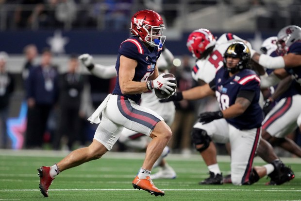 East's Efton Chism, left, of Eastern Washington, gains yards after a catch in the first half of the East West Shrine Bowl NCAA college football game in Arlington, Texas, Thursday, Jan. 30, 2025. (AP Photo/Tony Gutierrez)