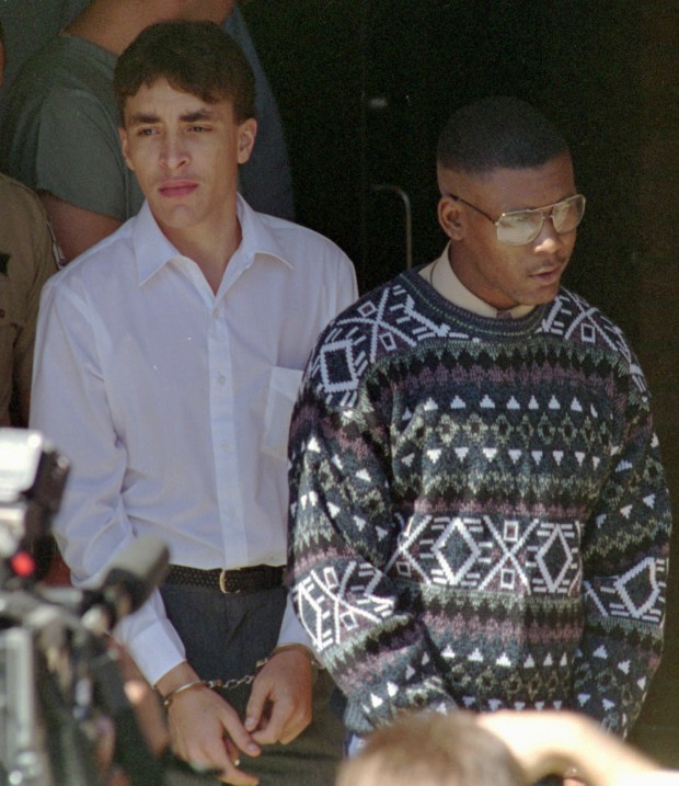 Larry Demery, left, and Daniel Green, charged with murdering James Jordan, father of NBA star Michael Jordan, leave the courthouse in Lumberton, North Carolina, after a hearing on Oct. 5, 1993. (Jim Bounds/AP)