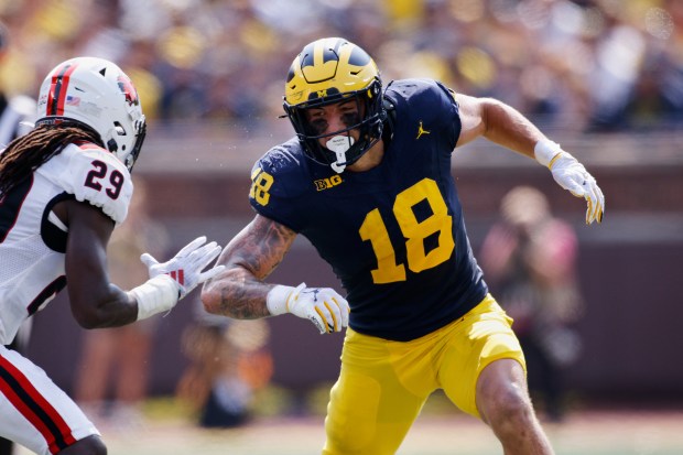Michigan tight end Colston Loveland maneuvers against Arkansas State safety...