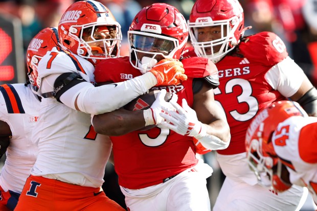 Rutgers running back Kyle Monangai is tackled by Illinois defensive back Matthew Bailey on Nov. 23, 2024, in Piscataway, N.J. (AP Photo/Rich Schultz)