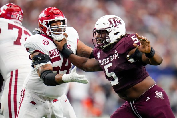 Texas A&M defensive lineman Shemar Turner (5) attacks against Arkansas offensive lineman Keyshawn Blackstock on Sept. 28, 2024, in Arlington, Texas. (Julio Cortez/AP)