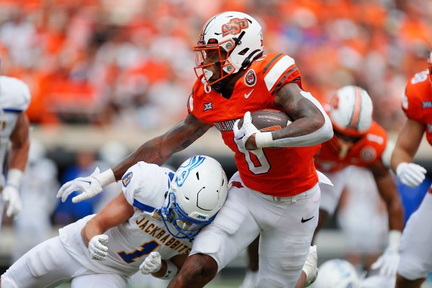 Running back Ollie Gordon II (0) of the Oklahoma State Cowboys powers his way into the end zone for a 12-yard touchdown past safety Tucker Large (1) of the South Dakota State Jackrabbits in the second quarter at Boone Pickens Stadium on Aug. 31, 2024 in Stillwater, Okla. Oklahoma State leads 17-6 after the first half. (Brian Bahr, Getty Images)