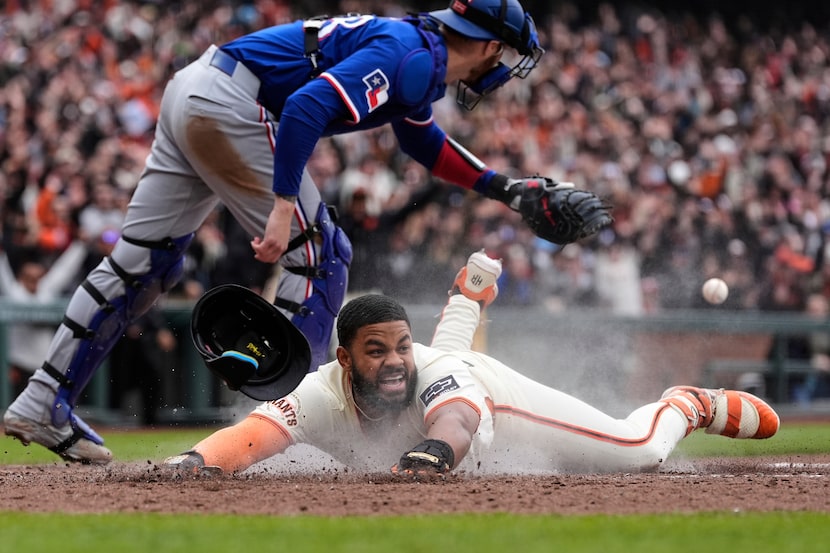 San Francisco Giants' Heliot Ramos scores the game-winning run on a throwing error by Texas...
