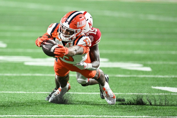 Pat Bryant #13 of the Illinois Fighting Illini reaches for extra yards against Ceyair Wright #15 of the Nebraska Cornhuskers during the third quarter at Memorial Stadium on Sept. 20, 2024 in Lincoln, Nebraska. (Photo by Steven Branscombe/Getty Images)