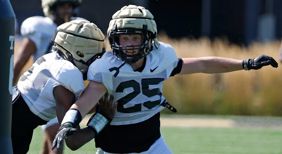 Purdue Boilermakers defensive back Luke Williams (5) and Purdue Boilermakers defensive back Ty Hudkins (25) run a drill Friday, Aug. 9, 2024, during Purdue football practice at Bimel Outdoor Practice Complex in West Lafayette, Ind.