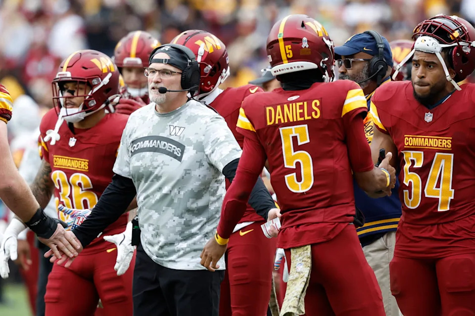 Washington Commanders head coach Dan Quinn (L) and quarterback Jayden Daniels (5). Geoff Burke-Imagn Images