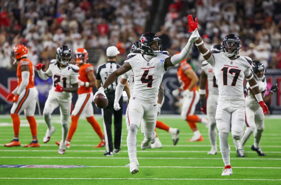 Sep 15, 2024; Houston, Texas, USA; Houston Texans cornerback Kamari Lassiter (4) celebrates his interception against the Chicago Bears in the second half at NRG Stadium. Mandatory Credit: Thomas Shea-Imagn Images