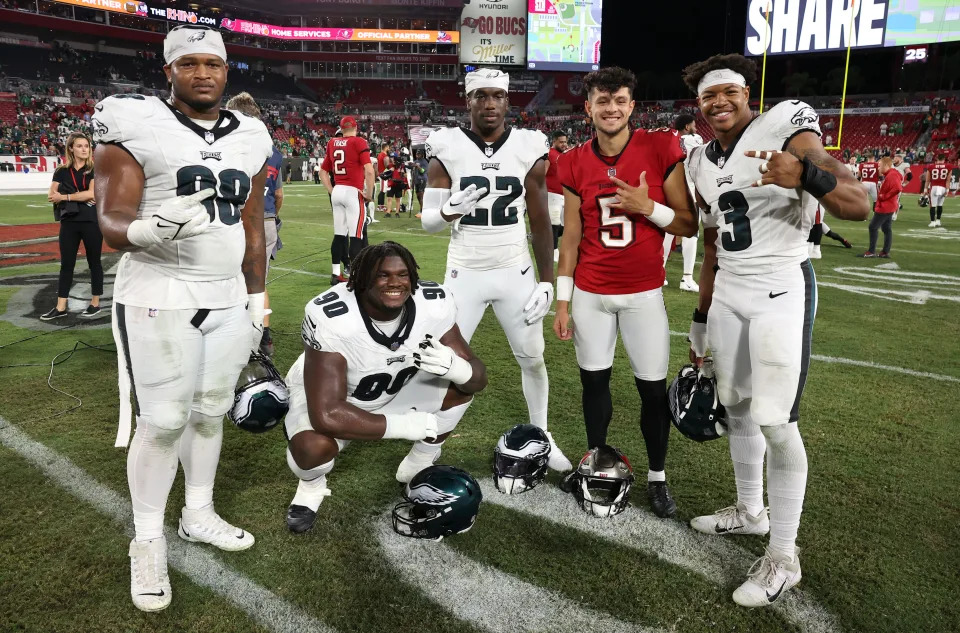 TAMPA, FLORIDA - SEPTEMBER 25: Former Georgia Bulldogs Jalen Carter #98, Jordan Davis #90, Kelee Ringo #22, and Nolan Smith #3 of the Philadelphia Eagles pose for a photo with Jake Camarda #5 of the Tampa Bay Buccaneers after their game at Raymond James Stadium on September 25, 2023 in Tampa, Florida. The Eagles defeated the Buccaneers by a score of 25-11. (Photo by Mike Carlson/Getty Images)