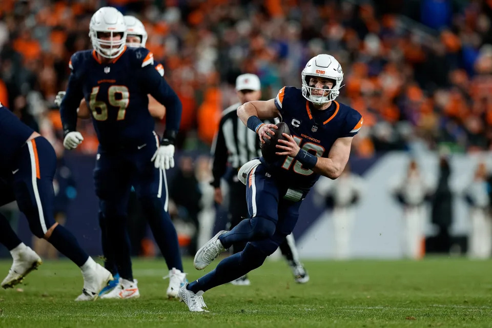 Dec 2, 2024; Denver, Colorado, USA; Denver Broncos quarterback Bo Nix (10) scrambles with the ball ahead of offensive tackle Mike McGlinchey (69) in the fourth quarter against the Cleveland Browns at Empower Field at Mile High. Mandatory Credit: Isaiah J. Downing-Imagn Images