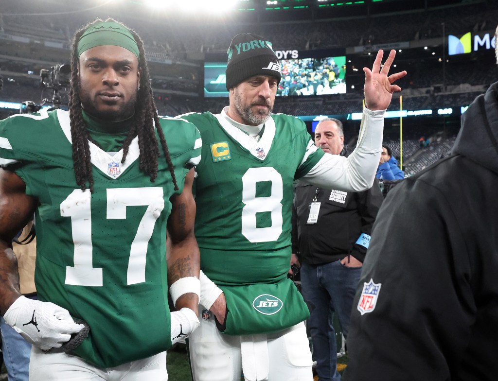 Aaron Rodgers and Davante Adams leave the field after their final game with the Jets.