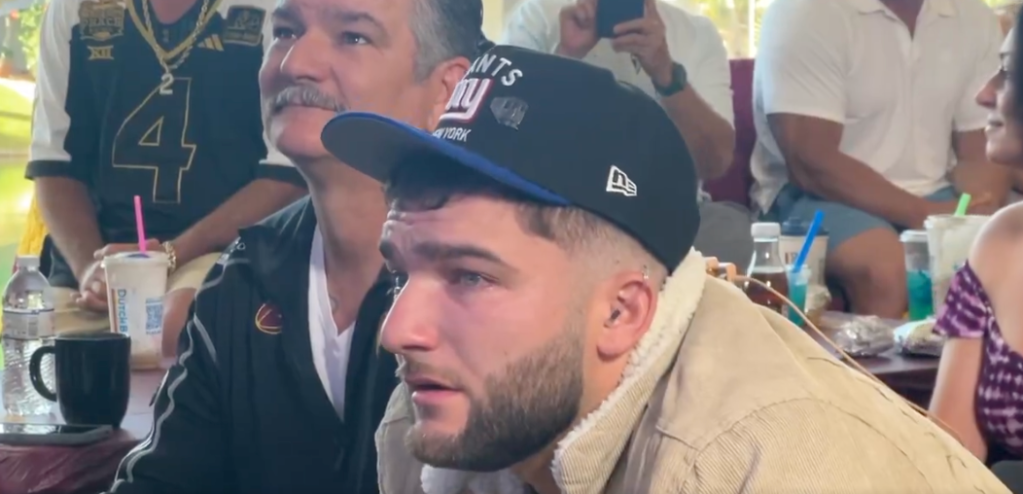 Cam Skattebo wearing a Giants hat.