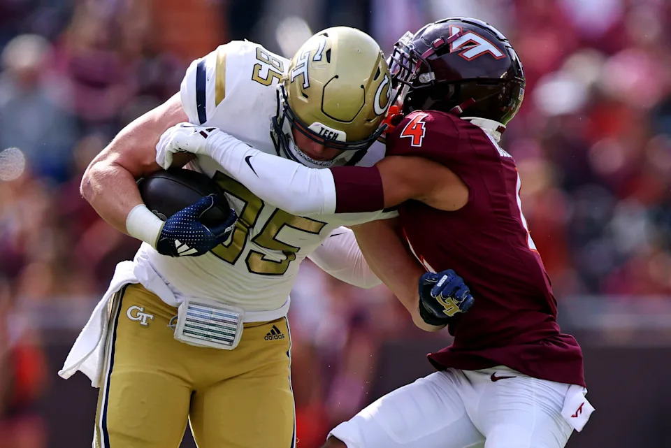 Oct 26, 2024; Blacksburg, Virginia, USA; Georgia Tech Yellow Jackets tight end Jackson Hawes (85) runs the ball after a catch against Virginia Tech Hokies cornerback Mansoor Delane (4) during the first quarter at Lane Stadium. Mandatory Credit: Peter Casey-Imagn Images