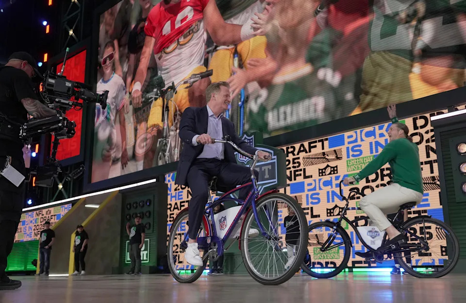 NFL commissioner Roger Goodell and former Packers player Clay Matthews ride bikes on the stage before the start of the first round of the NFL Draft on April 24.