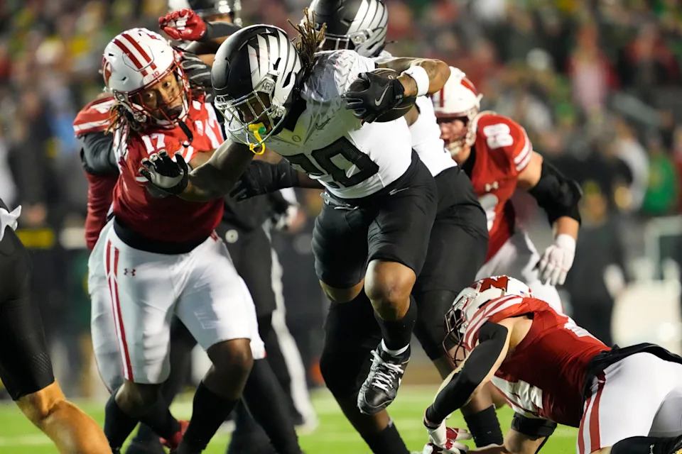 Nov 16, 2024; Madison, Wisconsin, USA; Oregon Ducks running back Jordan James (20) rushes with the football during the fourth quarter against the Wisconsin Badgers at Camp Randall Stadium. Mandatory Credit: Jeff Hanisch-Imagn Images
