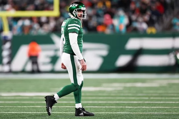 Aaron Rodgers #8 of the New York Jets walks off the field after an incompletion during the third quarter against the Miami Dolphins at MetLife Stadium on January 05, 2025 in East Rutherford, New Jersey