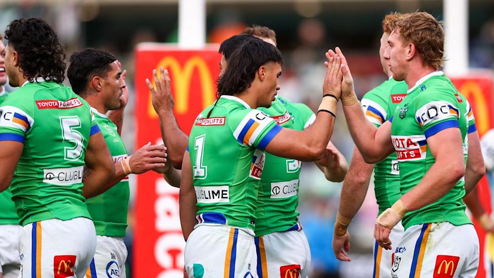 Raiders players celebrate one of their eight tries