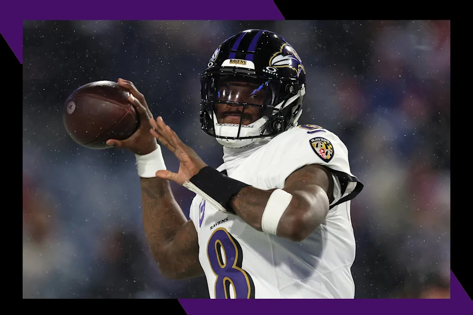 Baltimore Ravens quarterback Lamar Jackson readies to throw a pass.
