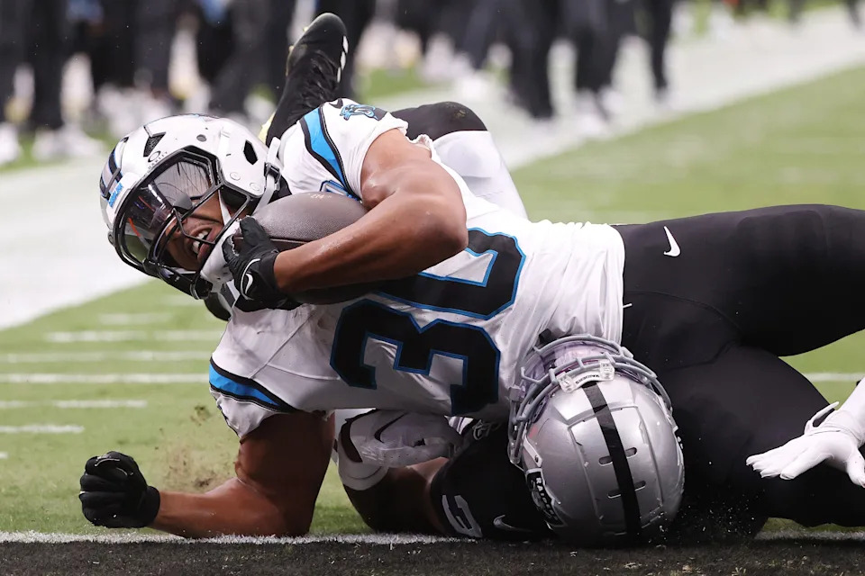 LAS VEGAS, NEVADA - SEPTEMBER 22: Chuba Hubbard #30 of the Carolina Panthers is tackled as he scores a receiving touchdown by Nate Hobbs #39 of the Las Vegas Raiders during the first quarter at Allegiant Stadium on September 22, 2024 in Las Vegas, Nevada. (Photo by Ian Maule/Getty Images)