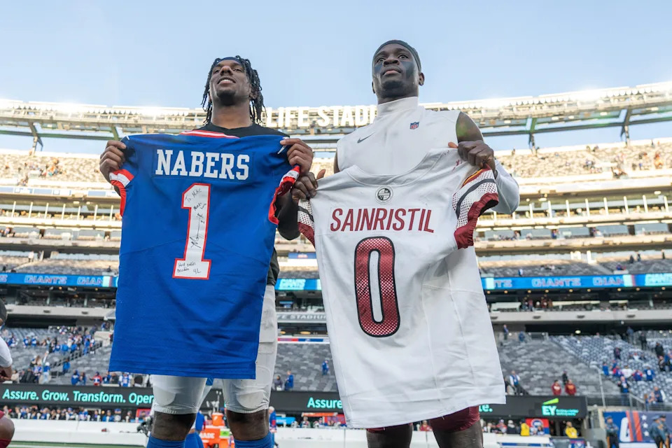 New York Giants wide receiver Malik Nabers (1) swaps jerseys with Washington Commanders cornerback Mike Sainristil (0) during a game between the New York Giants and the Washington Commanders at MetLife Stadium in East Rutherford on Sunday, Nov. 3, 2024.