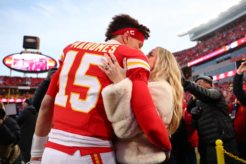 Kansas City Chiefs quarterback Patrick Mahomes (15) and Brittany Mahomes share a kiss before a game.Mark J&period; Rebilas-Imagn Images