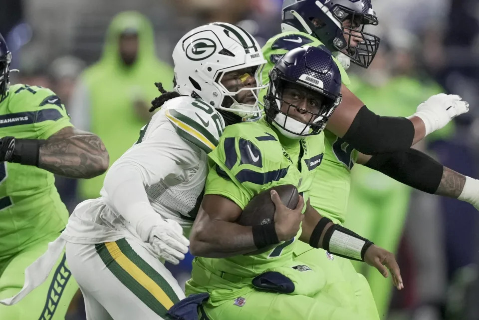 Green Bay Packers' Rashan Gary sacks Seattle Seahawks' Geno Smith during the first half of an NFL football game Sunday, Dec. 15, 2024, in Seattle. (AP Photo/Stephen Brashear)