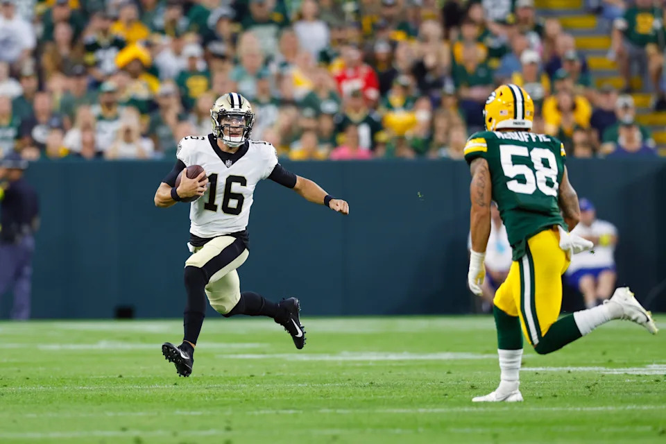 Aug 19, 2022; Green Bay, Wisconsin, USA; New Orleans Saints quarterback Ian Book (16) rushes with the football during the first quarter against the Green Bay Packers at Lambeau Field. Mandatory Credit: Jeff Hanisch-USA TODAY Sports