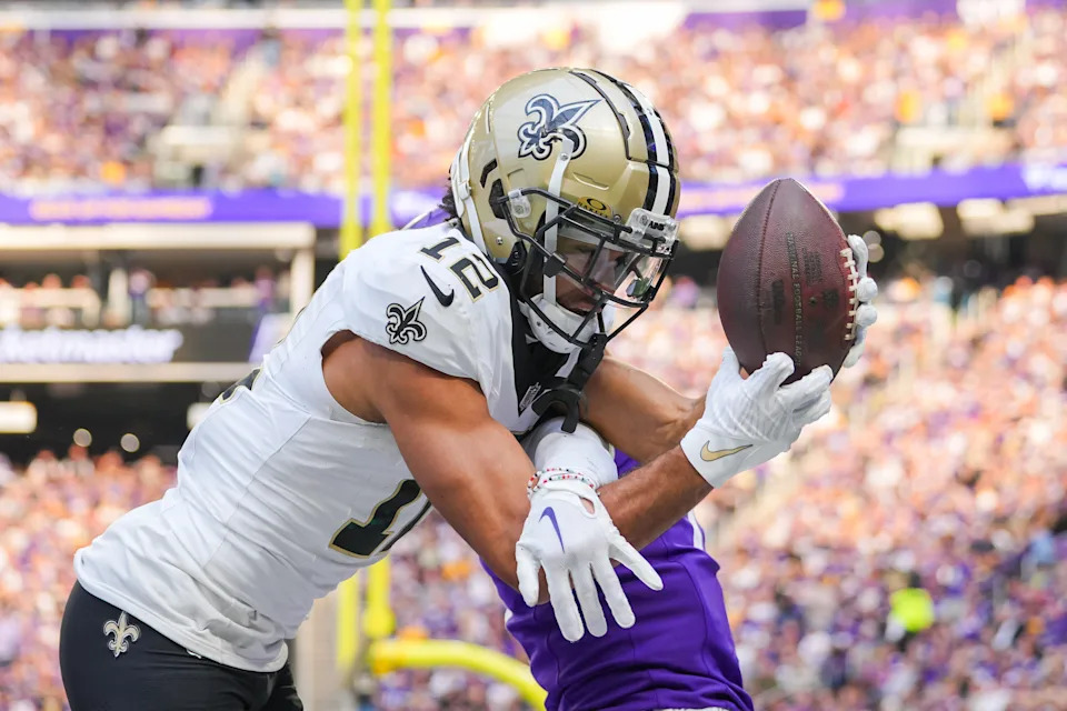 Nov 12, 2023; Minneapolis, Minnesota, USA; New Orleans Saints wide receiver Chris Olave (12) catches a pass for a touchdown against the Minnesota Vikings in the third quarter at U.S. Bank Stadium. Mandatory Credit: Brad Rempel-USA TODAY Sports