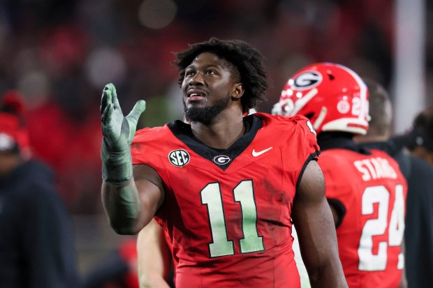 Georgia linebacker Jalon Walker reacts to the replay after the Bulldogs caused a Georgia Tech turnover during the fourth quarter Nov. 29, 2024, in Athens, Ga. (Jason Getz/The Atlanta Journal-Constitution)