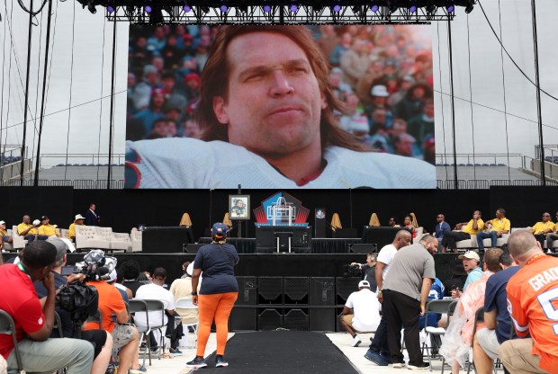 Steve McMichael is displayed on the video board as he is inducted into the Pro Football Hall of Fame during the enshrinement ceremony at Tom Benson Hall of Fame Stadium on Aug. 3, 2024, in Canton, Ohio. (John J. Kim/Chicago Tribune)
