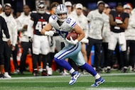 Dallas Cowboys tight end Jake Ferguson (87) looks up field after making a catch during the...