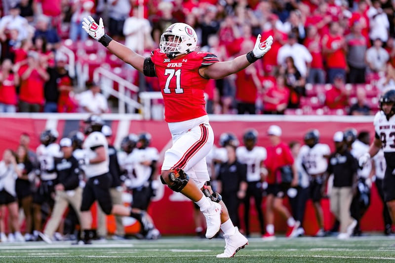 Utah offensive tackle Caleb Lomu celebrates a big play during game against
Southern Utah at Rice-Eccles Stadium in Salt Lake City, Utah, on Thursday, Aug. 29, 2024.
