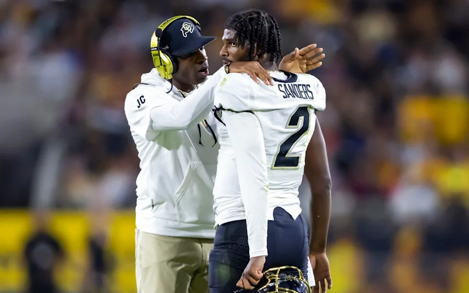Colorado Buffaloes head coach Deion Sanders with son and quarterback Shedeur Sanders (2).Mark J&period; Rebilas-Imagn Images