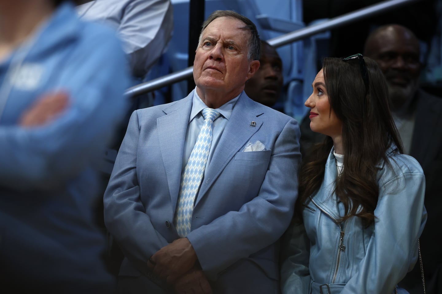 North Carolina Tar Heels football head coach Bill Belichick and his girlfriend, Jordon Hudson, looked on during the first half of the game between the North Carolina Tar Heels and the Duke Blue Devils on March 8 in Chapel Hill, N.C. 