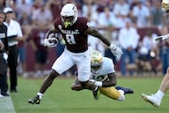 Texas A&M running back Le'Veon Moss (8) is tackled after a first down run by Notre Dame...