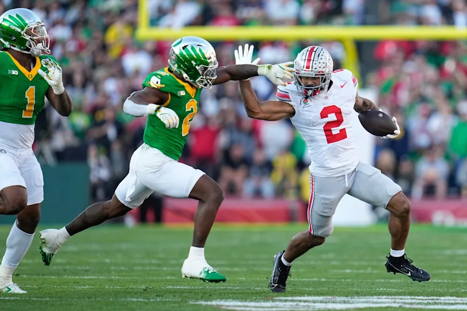 Ohio State wide receiver Emeka Egbuka brushes off Oregon Ducks tackler in College Football Playoff Game.Adam Cairns/Columbus Dispatch-USA TODAY NETWORK via Imagn Images