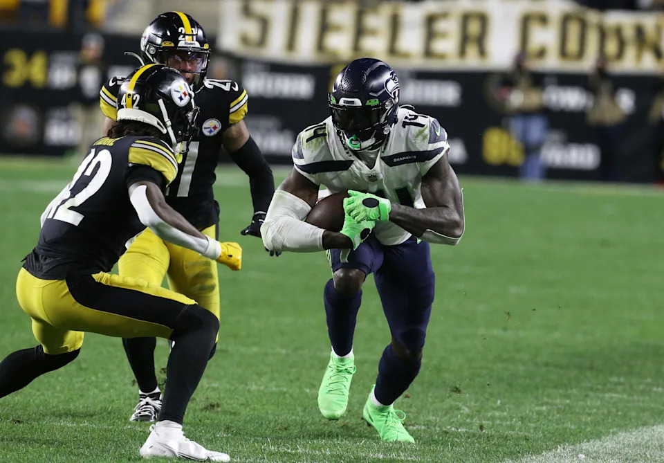 Oct 17, 2021; Pittsburgh, Pennsylvania, USA; Seattle Seahawks wide receiver DK Metcalf (14) runs after a pass reception as Pittsburgh Steelers cornerback James Pierre (42) and cornerback Tre Norwood (21) chase during the fourth quarter at Heinz Field. Pittsburgh won 23-20 in overtime. Mandatory Credit: Charles LeClaire-USA TODAY Sports