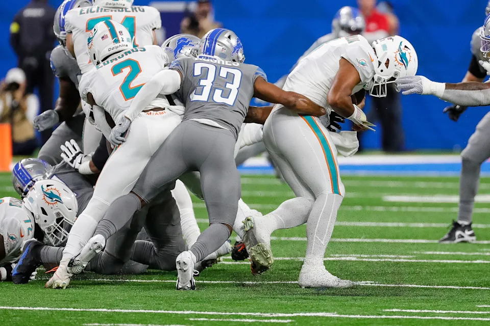 Detroit Lions safety JuJu Hughes tackles Miami Dolphins quarterback Tua Tagovailoa during the first half at Ford Field in Detroit on Sunday, Oct. 30, 2022.