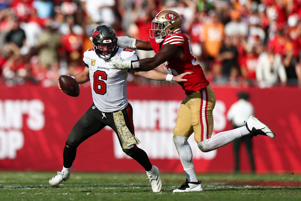 Nov 10, 2024; Tampa, Florida, USA; Tampa Bay Buccaneers quarterback Baker Mayfield (6) is pressured by San Francisco 49ers defensive end Leonard Floyd (56) in the fourth quarter at Raymond James Stadium.© Nathan Ray Seebeck-Imagn Images