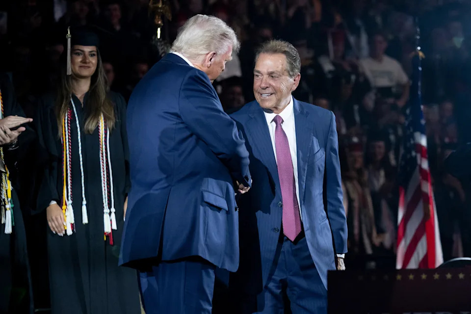 US President Donald Trump shakes hands with former Alabama football coach Nick Saban as he arrives to deliver commencement remarks at the University of Alabama in Tuscaloosa, Alabama, on May 1, 2025. (Photo by SAUL LOEB / AFP) (Photo by SAUL LOEB/AFP via Getty Images)          