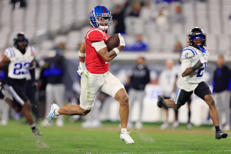 Mississippi Rebels wide receiver Jordan Watkins (11) outpaces Duke Blue Devils cornerback Diassa Diakite (23) and safety Jaylen Stinson (2) en route to a touchdown during the fourth quarter of the TaxSlayer Gator Bowl Thursday, Jan. 2, 2025 at EverBank Stadium in Jacksonville, Fla. Ole Miss defeated Duke 52-20. [Corey Perrine/Florida Times-Union]