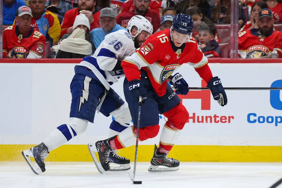 Tampa Bay Lightning right wing Nikita Kucherov (86) and Florida Panthers center Anton Lundell (15) battle for the puck at Amerant Bank Arena.Nathan Ray Seebeck-Imagn Images