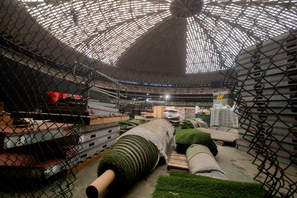 Rolls of turf are heaped among the ruins