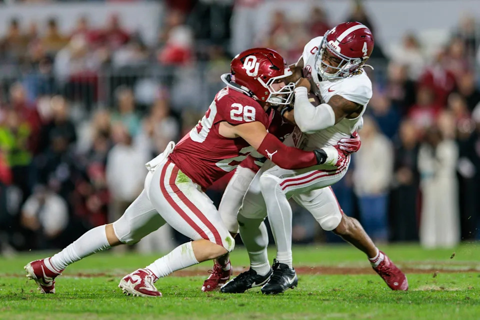 Alabama Crimson Tide quarterback Jalen Milroe (4) is tackled by Oklahoma Sooners linebacker Danny Stutsman (28). Mandatory Credit: William Purnell-Imagn Images
