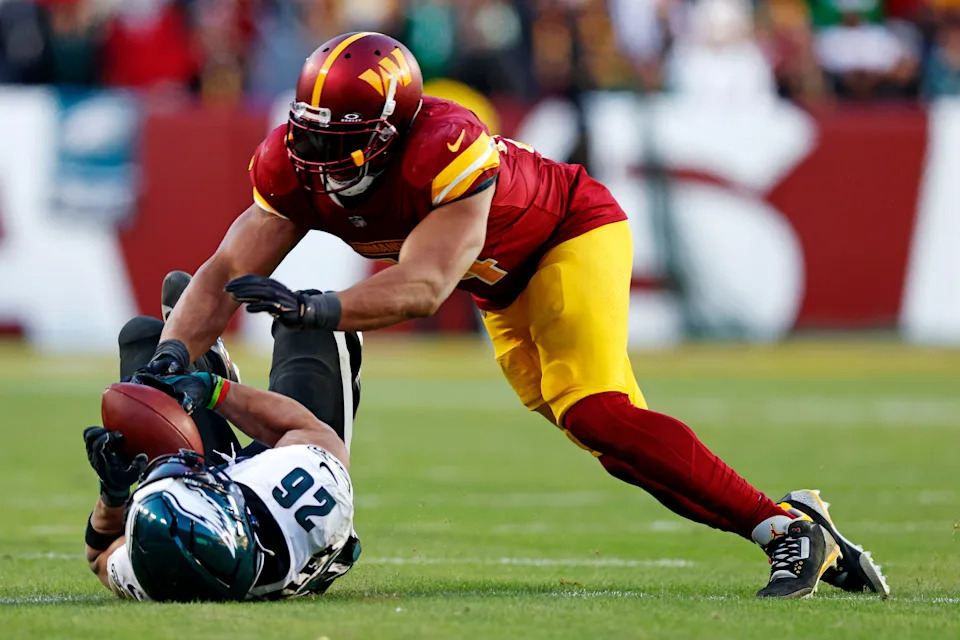 Dec 22, 2024; Landover, Maryland, USA; Philadelphia Eagles running back Saquon Barkley (26) drops a pass against Washington Commanders linebacker Bobby Wagner (54) during the fourth quarter at Northwest Stadium. Mandatory Credit: Peter Casey-Imagn Images